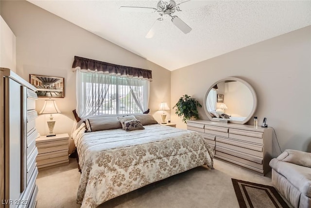 bedroom with light carpet, ceiling fan, lofted ceiling, and a textured ceiling