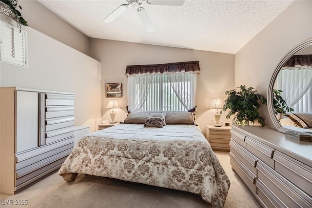 carpeted bedroom with ceiling fan, lofted ceiling, and a textured ceiling