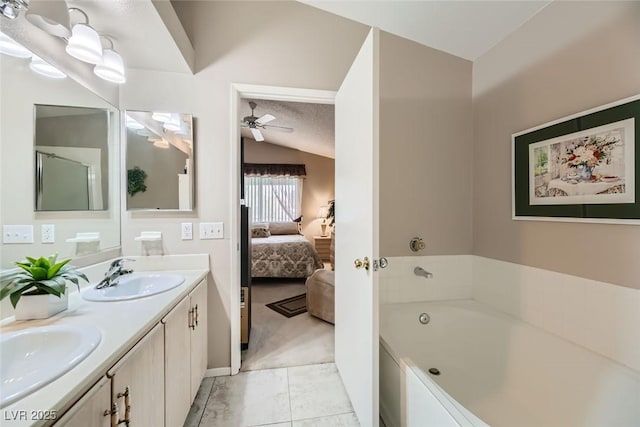 bathroom with vanity, a bath, vaulted ceiling, and ceiling fan