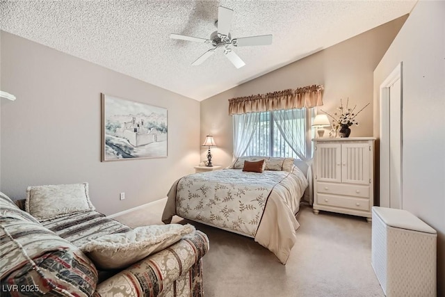 carpeted bedroom featuring ceiling fan, lofted ceiling, and a textured ceiling