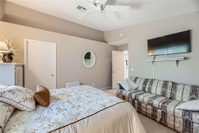 carpeted bedroom featuring ceiling fan, vaulted ceiling, and a textured ceiling