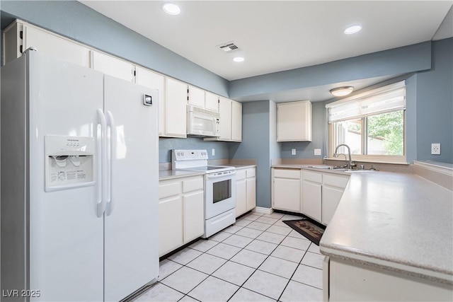 kitchen with white cabinetry, sink, light tile patterned flooring, and white appliances