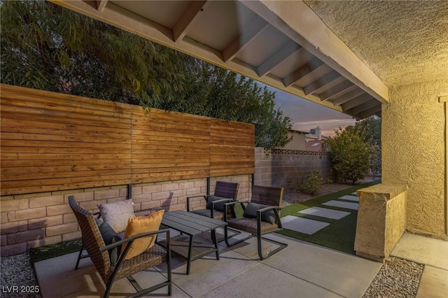 view of patio terrace at dusk