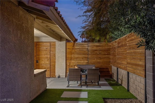 view of patio terrace at dusk