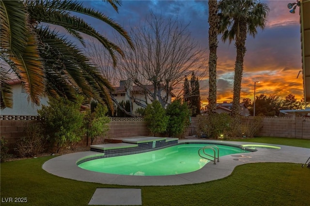 pool at dusk featuring a yard and a patio area