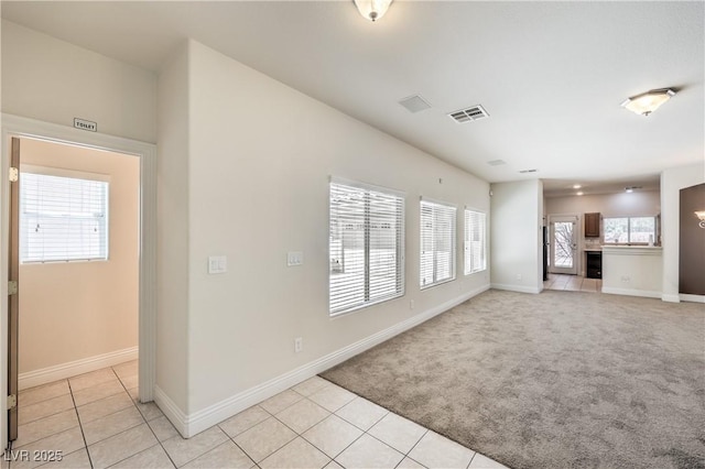 unfurnished living room featuring light colored carpet