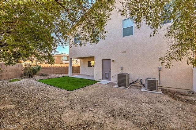 rear view of house with a patio and central AC