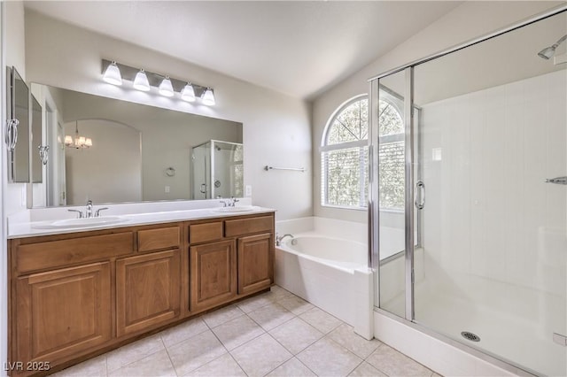 bathroom featuring tile patterned flooring, vanity, and separate shower and tub