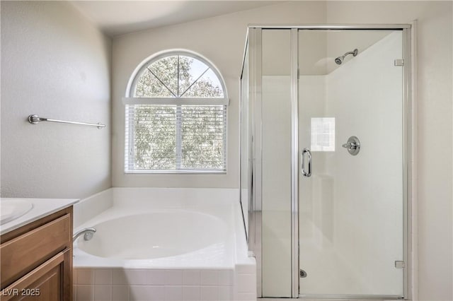 bathroom featuring vanity and independent shower and bath