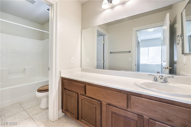 full bathroom featuring washtub / shower combination, tile patterned floors, toilet, and vanity