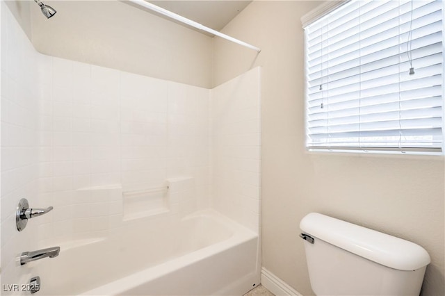 bathroom featuring toilet and tub / shower combination