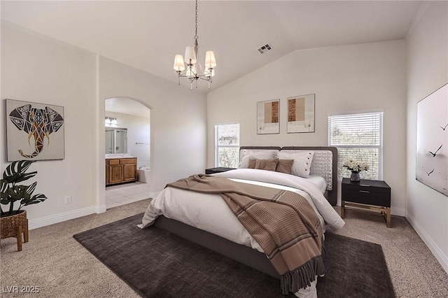 bedroom featuring lofted ceiling, a notable chandelier, light colored carpet, and ensuite bathroom