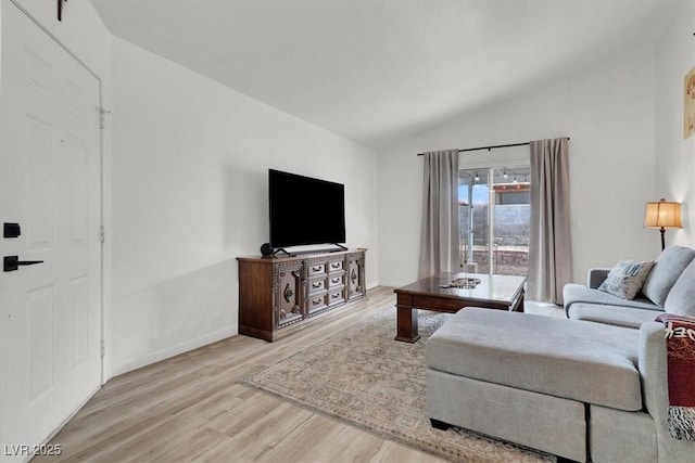 living room with lofted ceiling and light hardwood / wood-style flooring