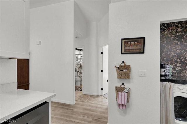 interior space with wine cooler, washer / clothes dryer, and light hardwood / wood-style floors