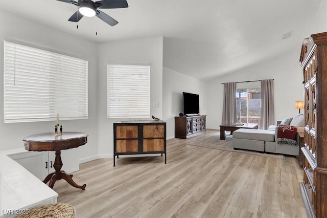 interior space featuring ceiling fan, lofted ceiling, and light hardwood / wood-style floors