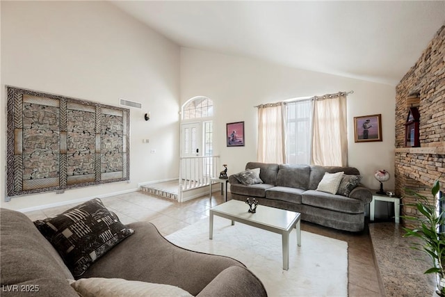 tiled living room with high vaulted ceiling