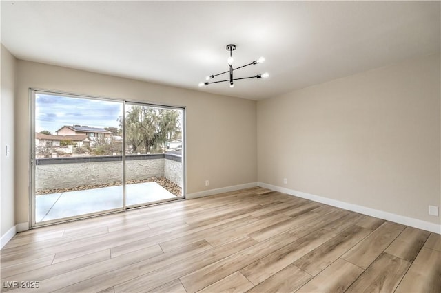 unfurnished dining area with a chandelier and light hardwood / wood-style floors