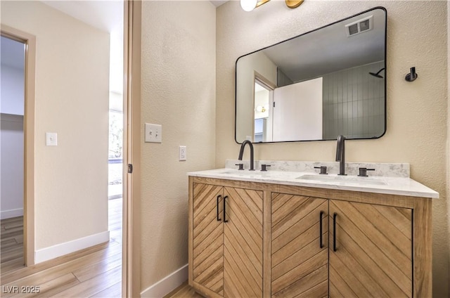 bathroom featuring hardwood / wood-style flooring and vanity