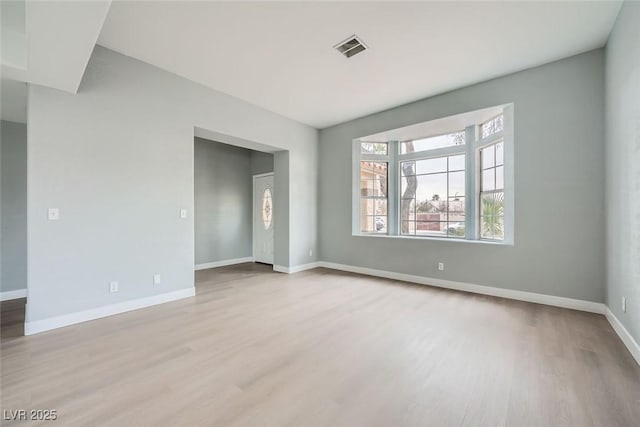 spare room featuring light wood-type flooring