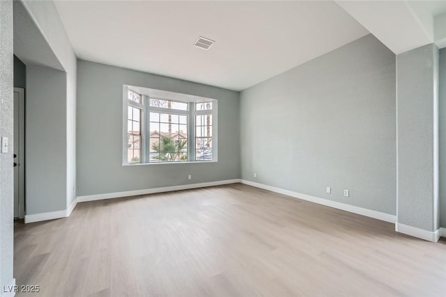 spare room featuring light hardwood / wood-style floors