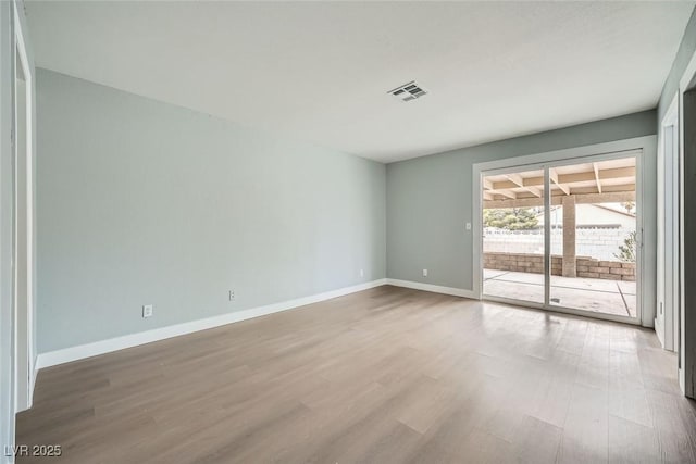 spare room with hardwood / wood-style flooring