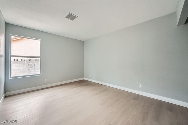 spare room featuring light hardwood / wood-style floors