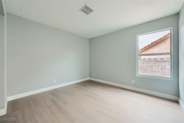 spare room featuring light hardwood / wood-style flooring