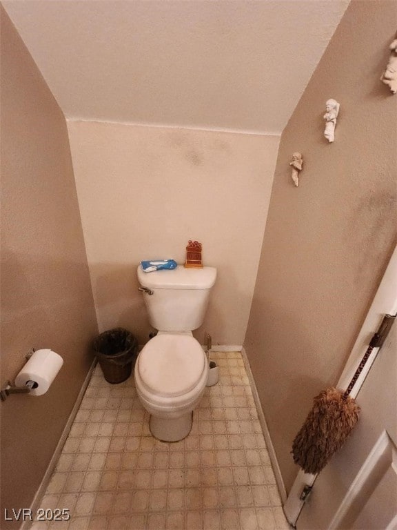 bathroom with toilet and vaulted ceiling