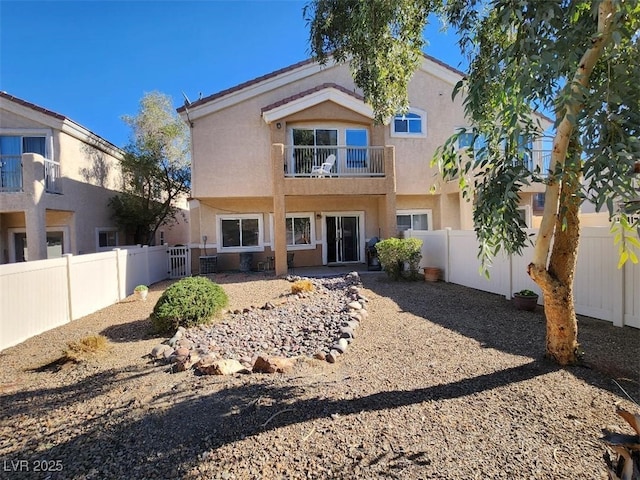 back of property featuring a balcony