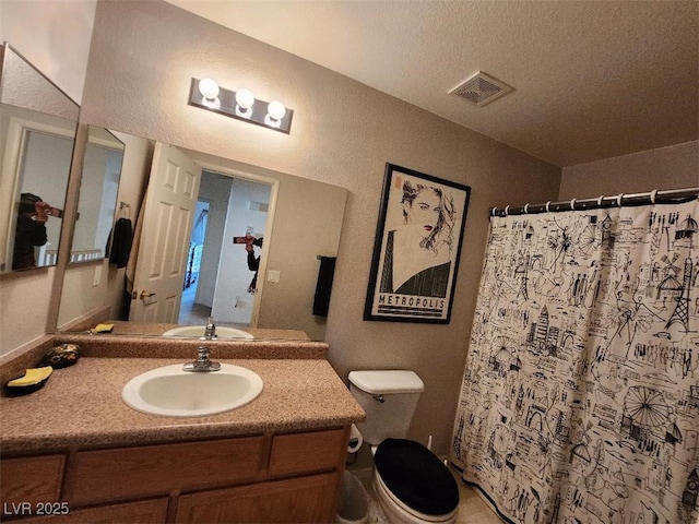 bathroom featuring vanity, a shower with shower curtain, and toilet