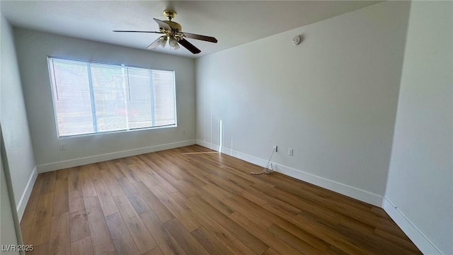 empty room with hardwood / wood-style flooring and ceiling fan