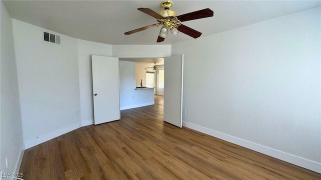 empty room with hardwood / wood-style flooring and ceiling fan