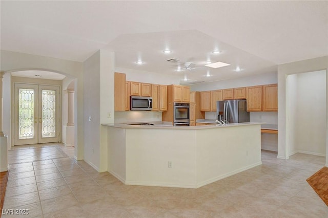 kitchen with light brown cabinetry, ceiling fan, kitchen peninsula, stainless steel appliances, and french doors