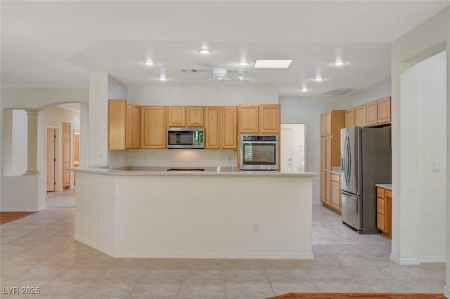 kitchen featuring ceiling fan, stainless steel appliances, light brown cabinetry, kitchen peninsula, and ornate columns