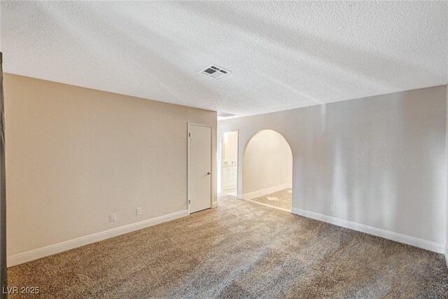 carpeted spare room featuring a textured ceiling