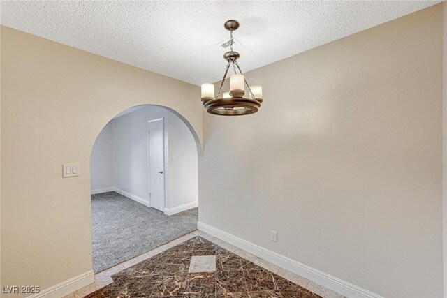 unfurnished room with a textured ceiling