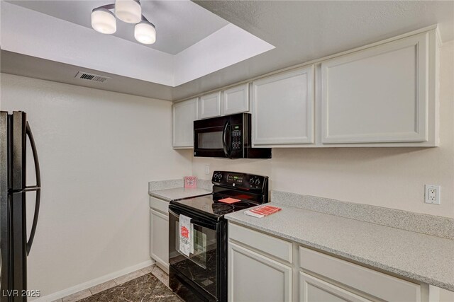 kitchen featuring white cabinetry and black appliances