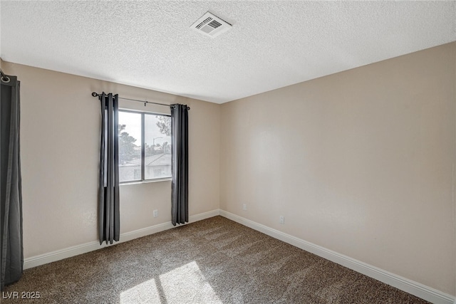 unfurnished room featuring carpet and a textured ceiling