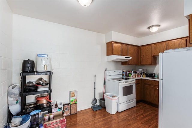 kitchen featuring dark hardwood / wood-style flooring and white appliances