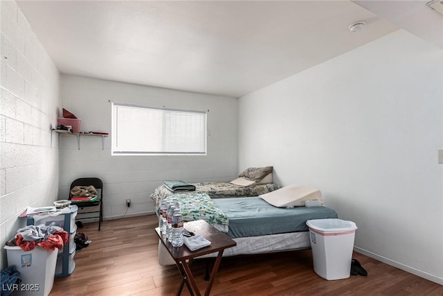 bedroom with hardwood / wood-style flooring