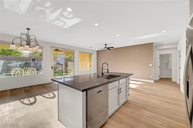 kitchen featuring pendant lighting, sink, white cabinetry, a center island with sink, and stainless steel dishwasher