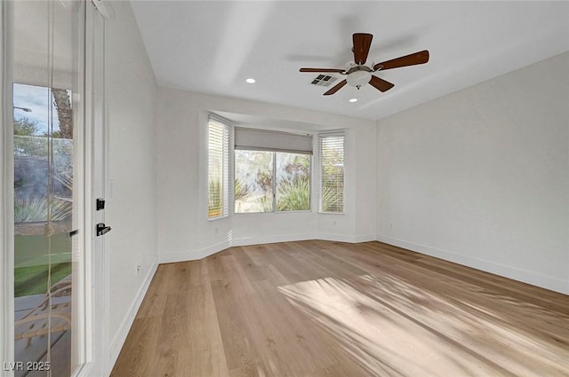 spare room with light hardwood / wood-style flooring and ceiling fan