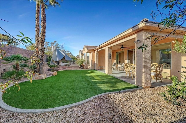 view of yard featuring ceiling fan and a patio area