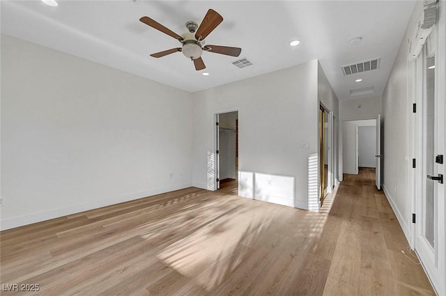 unfurnished room with ceiling fan and light wood-type flooring