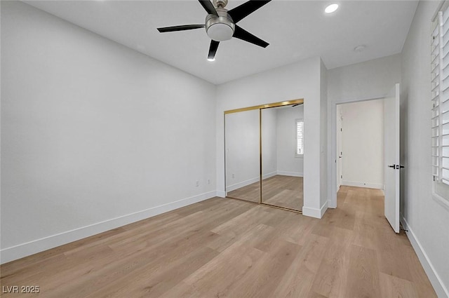 unfurnished bedroom featuring light hardwood / wood-style floors, a closet, and ceiling fan