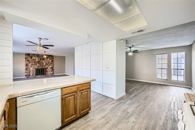 3954 Edgemoor Way, Las Vegas, NV 89121 - kitchen featuring white dishwasher, a ceiling fan, open floor plan, and brown cabinetry