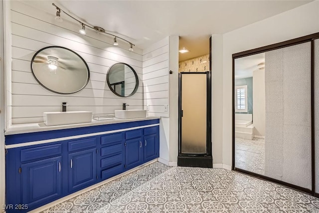 3954 Edgemoor Way, Las Vegas, NV 89121 - bathroom with double vanity, a stall shower, rail lighting, and tile patterned flooring