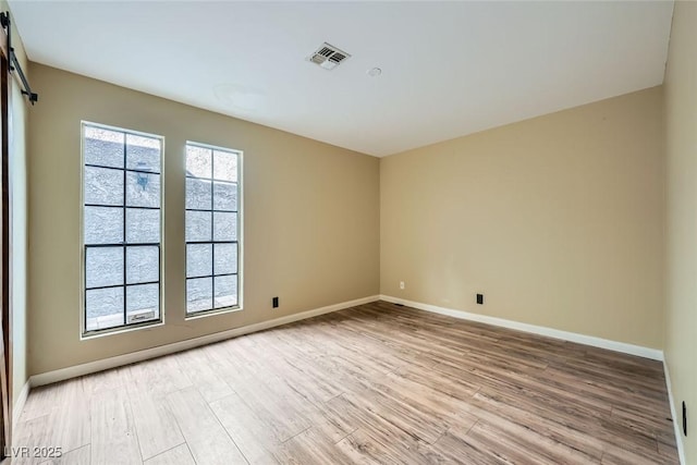3954 Edgemoor Way, Las Vegas, NV 89121 - spare room with light wood finished floors and a barn door