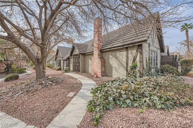 3954 Edgemoor Way, Las Vegas, NV 89121 - view of front of home with stucco siding, a chimney, and a tile roof