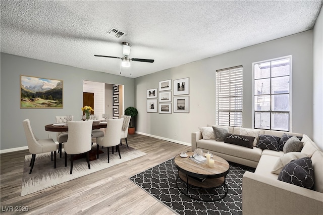 3954 Edgemoor Way, Las Vegas, NV 89121 - living room with wood finished floors, a ceiling fan, and a textured ceiling